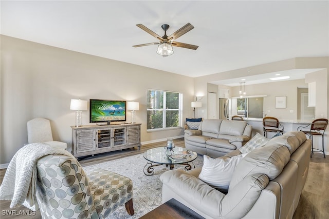 living room featuring ceiling fan and hardwood / wood-style flooring