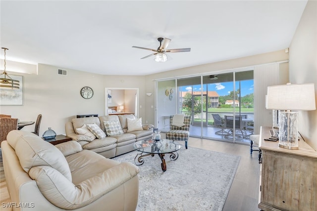 living room featuring ceiling fan and light hardwood / wood-style floors