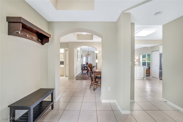 hall featuring light tile patterned floors