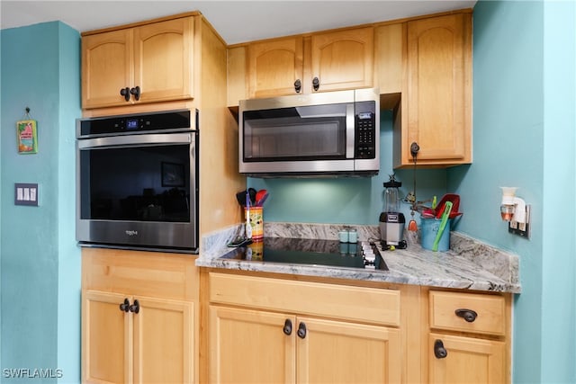 kitchen featuring light brown cabinets and appliances with stainless steel finishes