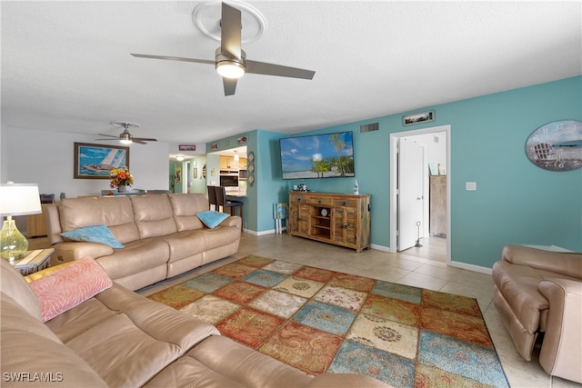 living room with ceiling fan and light tile patterned floors