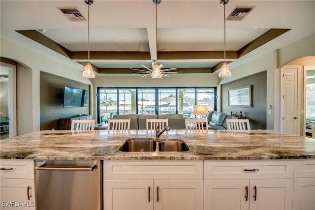 kitchen featuring white cabinets, decorative light fixtures, plenty of natural light, and sink