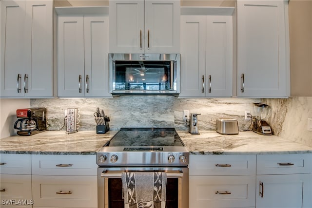 kitchen with white cabinetry, appliances with stainless steel finishes, and tasteful backsplash