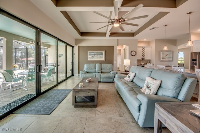 living room with ceiling fan and coffered ceiling