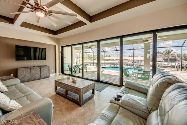 living room featuring ceiling fan and beamed ceiling