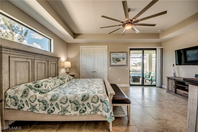 bedroom featuring a closet, multiple windows, access to outside, and ceiling fan