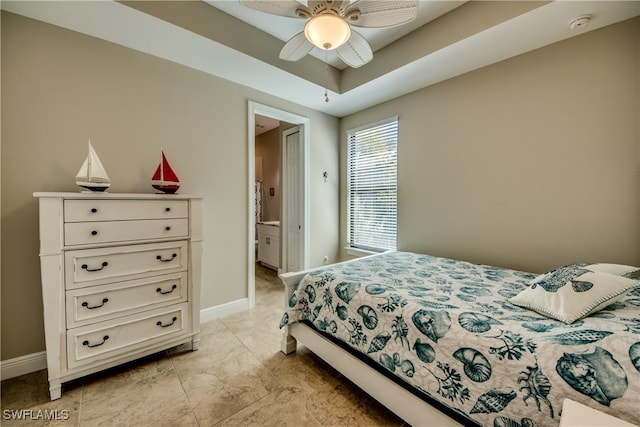 bedroom with ensuite bath and ceiling fan