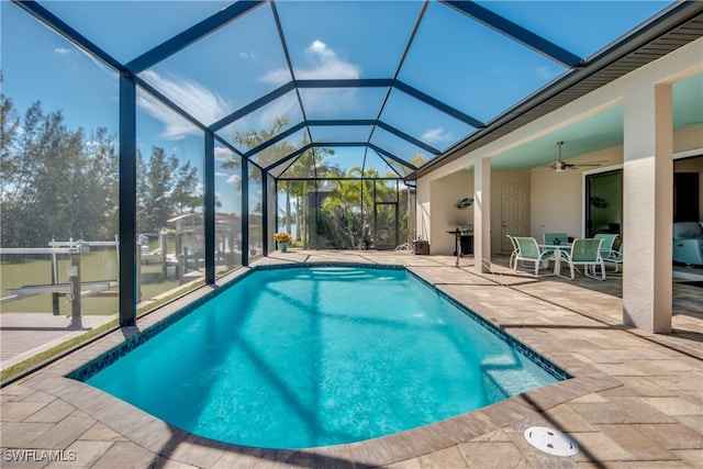 view of pool with a lanai, a patio area, and ceiling fan