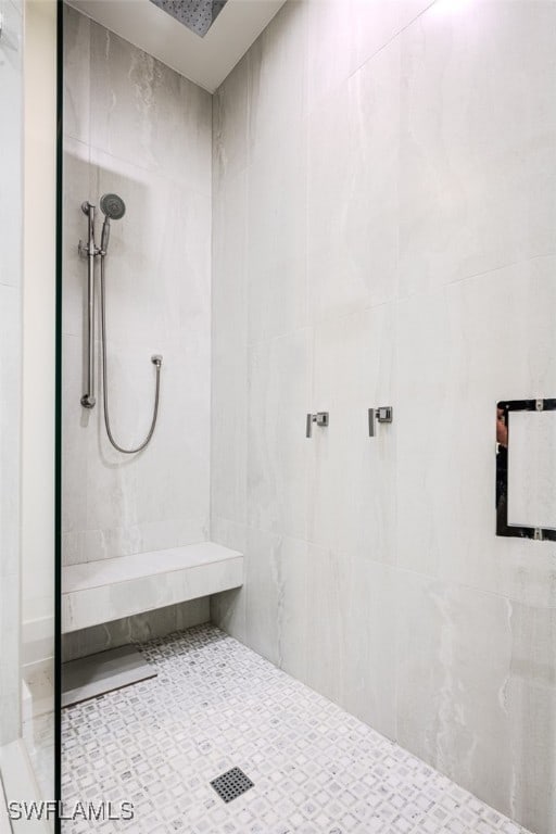 bathroom with a tile shower