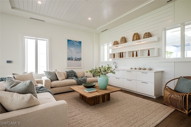 living room featuring wood ceiling, wooden walls, and hardwood / wood-style floors