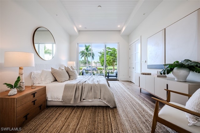 bedroom with access to outside, wood ceiling, and hardwood / wood-style flooring