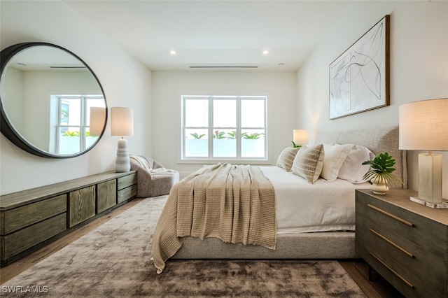 bedroom featuring multiple windows and hardwood / wood-style flooring