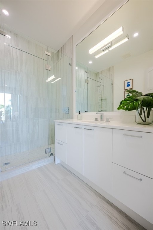 bathroom featuring vanity and an enclosed shower