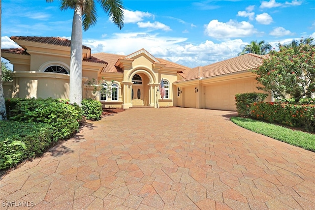 mediterranean / spanish-style house with a garage