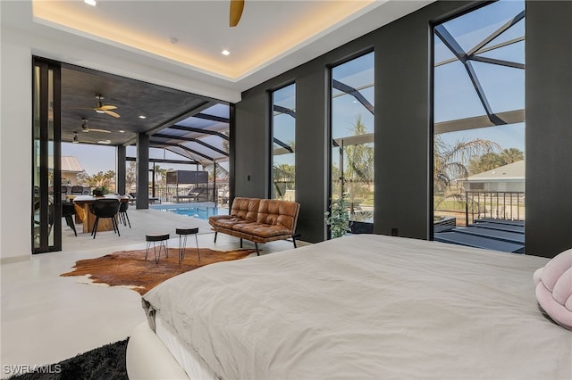 bedroom featuring a tray ceiling and access to outside