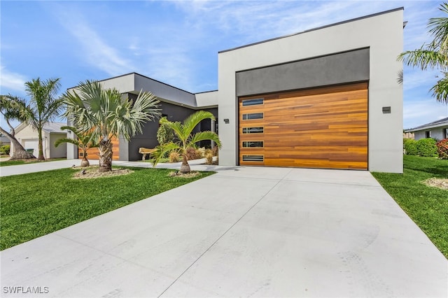 contemporary house featuring a garage and a front yard