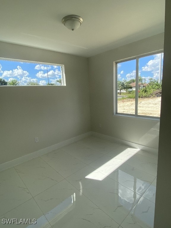 spare room with a healthy amount of sunlight