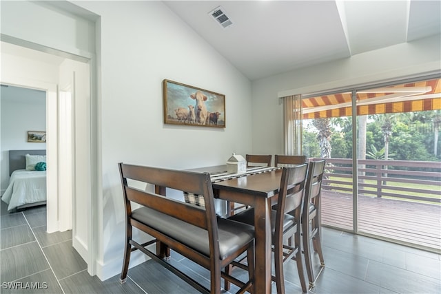 dining area featuring vaulted ceiling