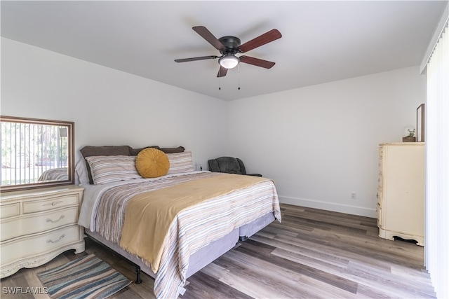 bedroom featuring hardwood / wood-style floors and ceiling fan