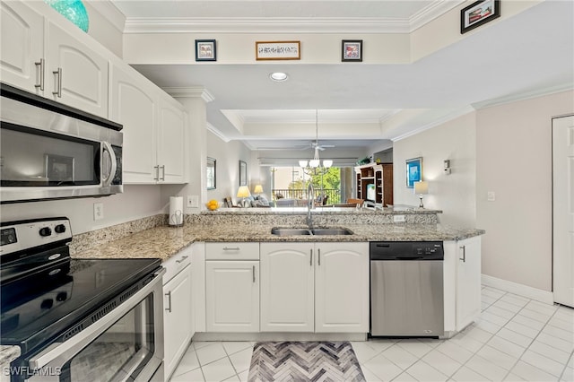 kitchen with white cabinetry, kitchen peninsula, light stone countertops, stainless steel appliances, and sink