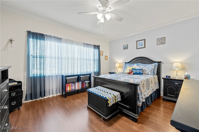 bedroom featuring ceiling fan, hardwood / wood-style floors, and crown molding