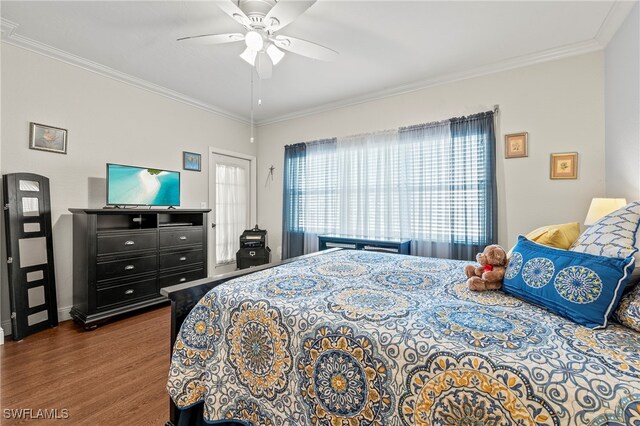 bedroom with ornamental molding, ceiling fan, and dark hardwood / wood-style flooring