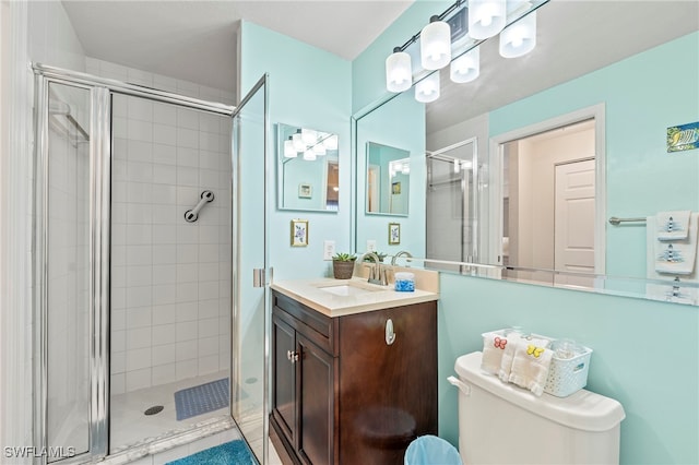 bathroom featuring walk in shower, vanity, and toilet