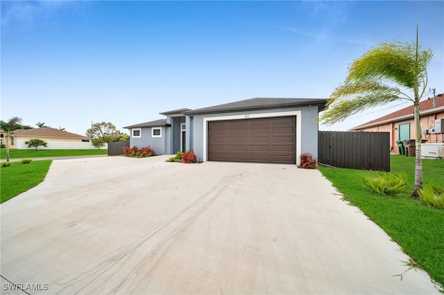 ranch-style house featuring a garage and a front yard