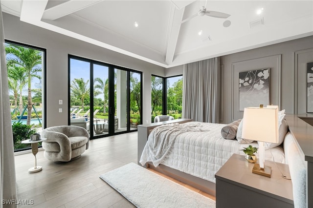 bedroom featuring lofted ceiling with beams, access to exterior, light wood-type flooring, and multiple windows