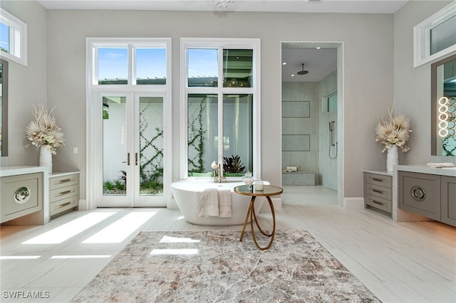 bathroom featuring vanity, separate shower and tub, and plenty of natural light