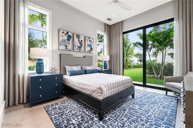 bedroom featuring access to exterior, ceiling fan, crown molding, and hardwood / wood-style flooring