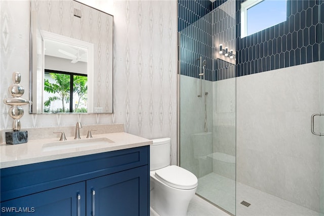 bathroom featuring a wealth of natural light, ceiling fan, a shower with shower door, and toilet