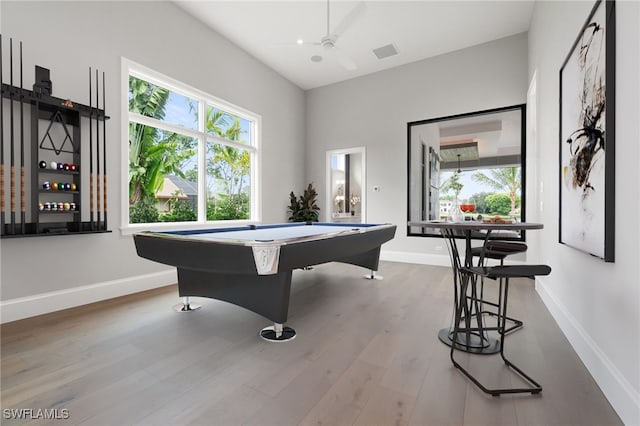 rec room featuring a wealth of natural light, light wood-type flooring, ceiling fan, and billiards