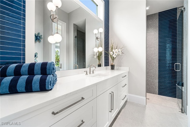 bathroom featuring an enclosed shower, vanity, tile patterned floors, and a wealth of natural light