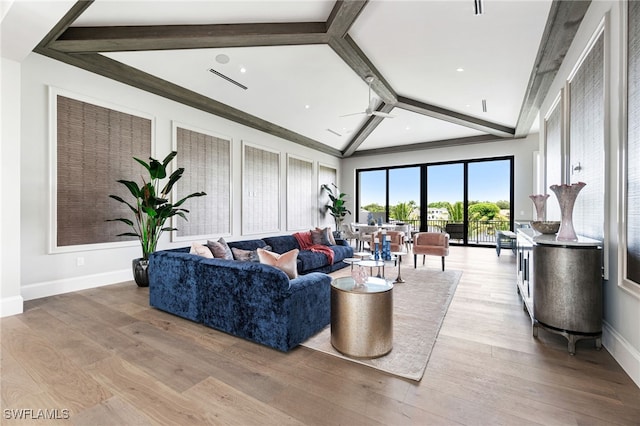 living room with light hardwood / wood-style flooring and lofted ceiling