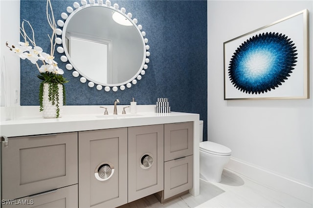 bathroom featuring vanity and toilet