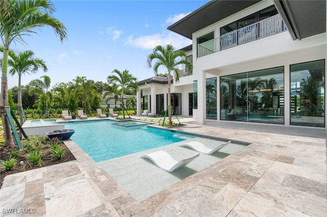 view of pool featuring a patio area and a hot tub