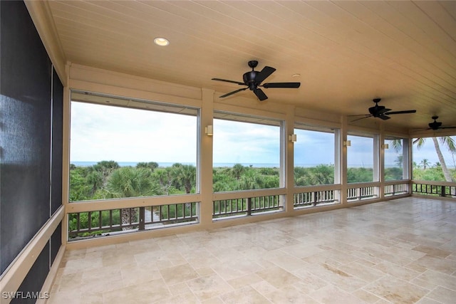 unfurnished sunroom with ceiling fan and wood ceiling