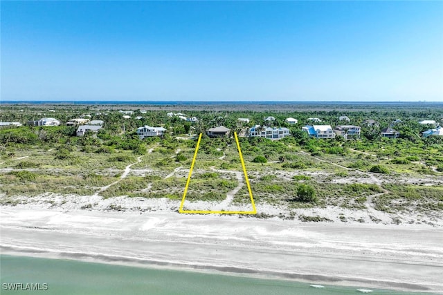 drone / aerial view with a water view and a beach view