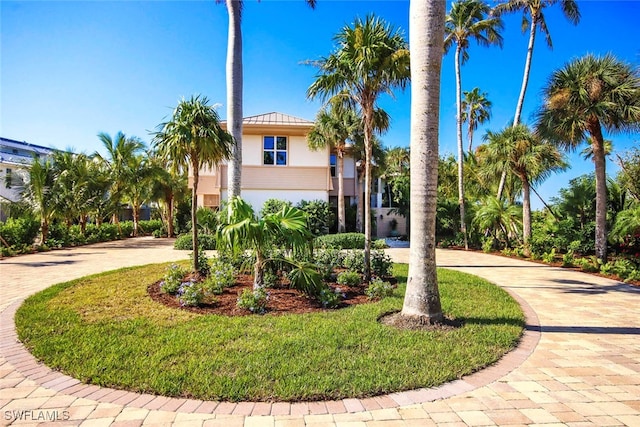 mediterranean / spanish-style home with a front yard