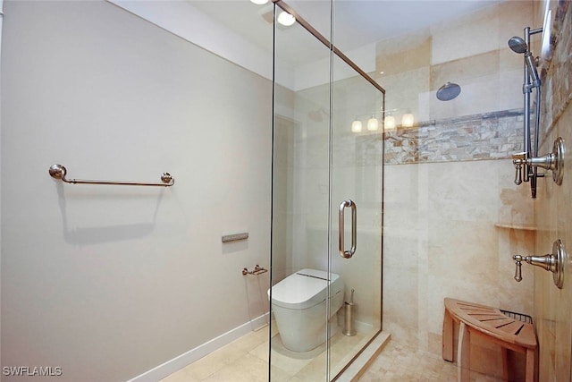 bathroom with tile patterned flooring, a shower with door, and toilet