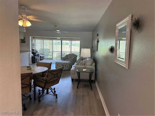 dining space with ceiling fan and dark hardwood / wood-style floors