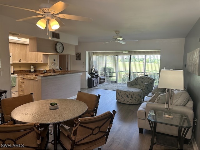 dining area with ceiling fan and dark hardwood / wood-style flooring