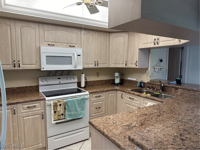 kitchen featuring white appliances, light tile patterned floors, ceiling fan, dark stone counters, and sink