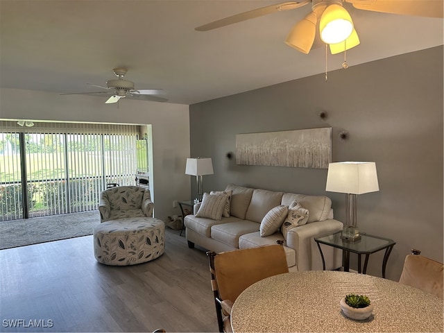 living room featuring wood-type flooring and ceiling fan