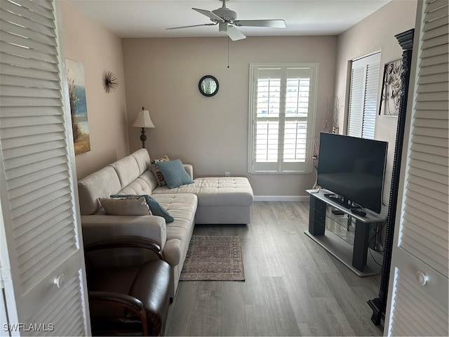 living room with light wood-type flooring and ceiling fan