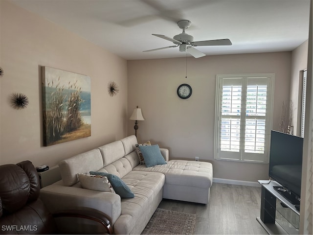 living room featuring ceiling fan and hardwood / wood-style floors