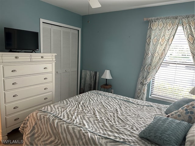 bedroom with ceiling fan and a closet