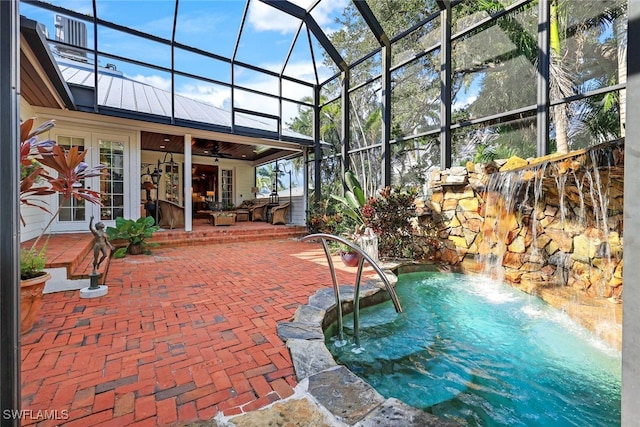 view of pool featuring ceiling fan, french doors, a patio area, pool water feature, and a lanai