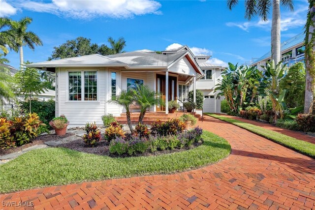 view of front of property with covered porch and a garage